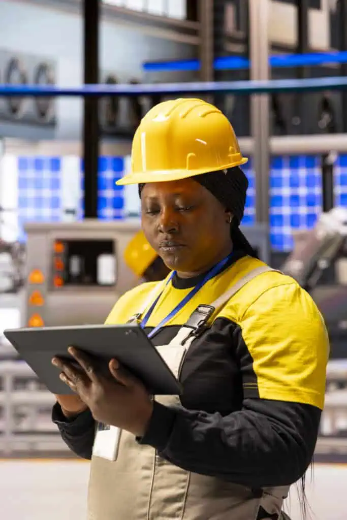 Woman automation engineer doing quality control in high tech industrial facility