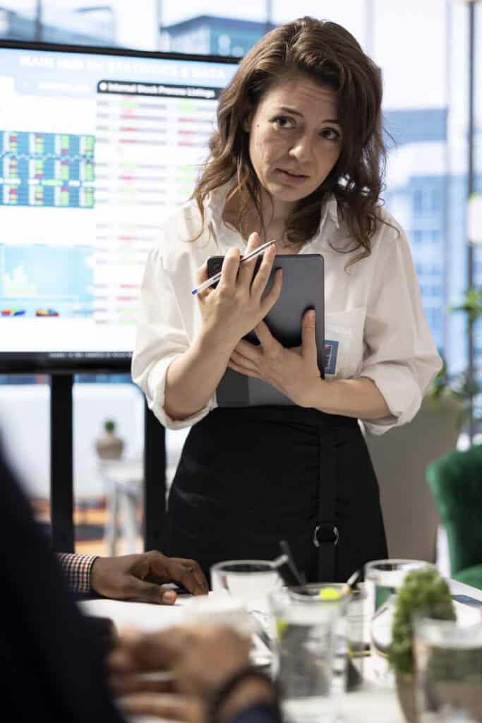 Business team looking into infographics and analytics to solve problems within the project progress