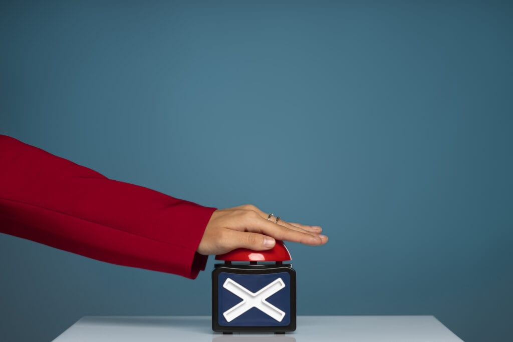 Side view of hand pressing X button