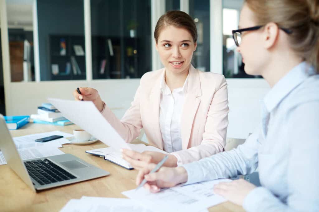 Two female payroll specialists working together