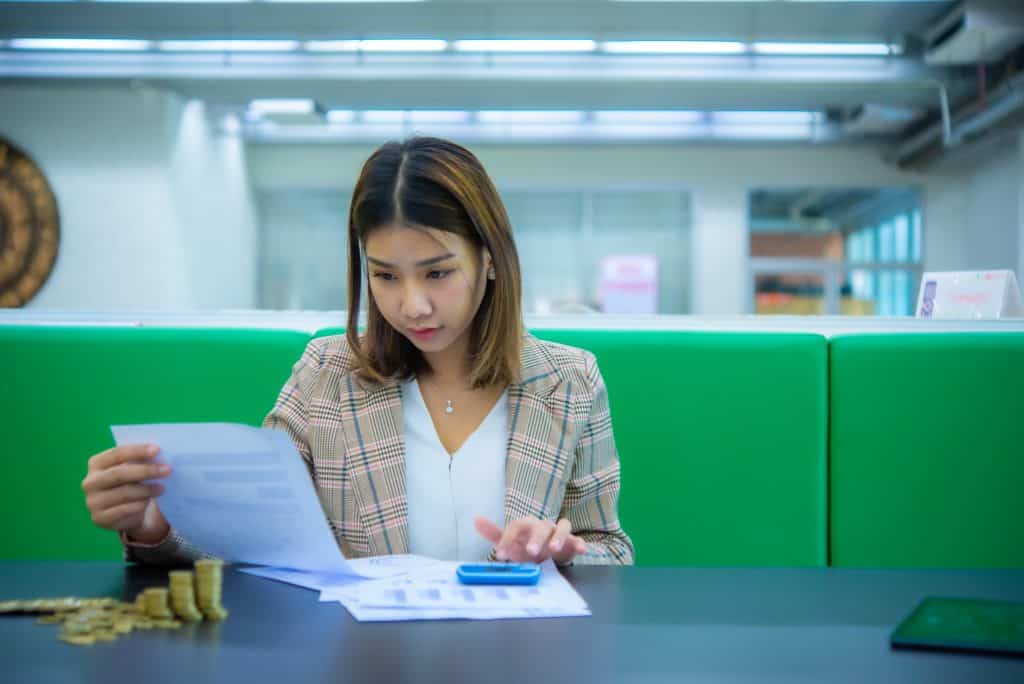 Cost reduction services expert working in an office, calculating costs